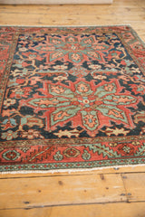 Serrated leaf main border with blue vinery and fringe on this antique Heriz rug.