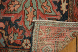 Antique Heriz rug pile with serrated leaves and vinery, folded to show hand-knotted foundation.