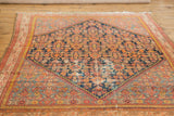 Vintage Malayer rug, Herati motif in navy, madder red, sky blue, with visible foundation wear.