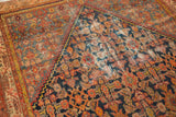 Vintage Persian Malayer rug, navy blue and madder red Herati motif with visible foundation wear.