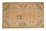 Vintage Chinese rug with central lion shield and dragon border, beige and blue tones.