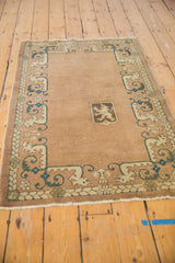 Vintage Chinese rug lower border with beige dragon motifs, teal accents, and fringe.