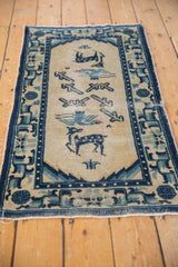Worn fringe and geometric cobalt blue border of the vintage hand-knotted Chinese Peking rug.