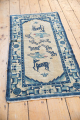 Worn lower right corner of the vintage Peking runner with cobalt blue geometric border.