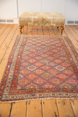 Antique Kurdish Malayer rug's end, featuring madder red boteh border and short fringe.