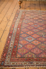 Antique Kurdish Malayer rug detail: geometric guls, boteh borders, madder red, sapphire blue, fringe.