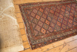 Antique Kurdish Malayer rug corner detail, madder red boteh borders, geometric field, secure fringe.