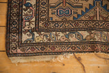 Antique Hamadan rug's corner with intricate geometric border, sand and blue patterns, and mostly secure ends.