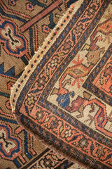 Antique Hamadan rug's secured side and woven texture featuring blue, copper, sand motifs.