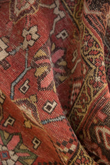 Textured antique Kurdish Bijar rug pile, blush, brick red Mina Khani pattern, and wear.