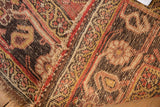 Antique Kurdish Bijar rug detail: worn pile, tattered edge, and foundation showing through.