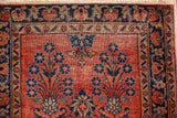 Ruby red Mohajeran Sarouk runner corner, navy floral sprays, intricate borders, visible foundation.
