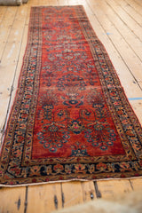 Vintage Mohajeran Sarouk runner: ruby red floral sprays, navy borders, and softened pile.