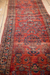 Ruby red field, navy and sky blue floral sprays on a vintage Sarouk runner.