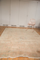 Fringed end of vintage Persian Kashan rug, soft beige field and even pile wear.