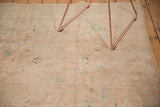 Vintage Kashan carpet field displaying even wear, soft beige, sand, and faded aqua patterns.