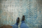 Distressed powder blue and beige Mahal rug with heavy abrashes and visible foundation.