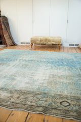 Distressed vintage Mahal rug showing textured powder blue pile and ornate charcoal border.