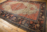 Antique Farahan Sarouk corner with navy, terra cotta, gold wide floral and pawn borders.