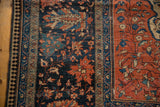 Antique Farahan Sarouk's wide terra cotta main border, unique reciprocating pawn design, and navy floral field.