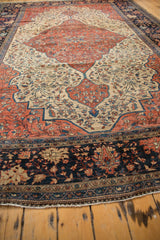 Antique Farahan Sarouk rug's unique navy floral main border and reciprocating pawn motif.