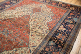 Antique Persian Farahan Sarouk navy border displaying intricate floral designs and unique reciprocating pawn motif.