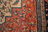 Antique Farahan Sarouk carpet's terra cotta field with delicate florals and navy reciprocating pawn border.