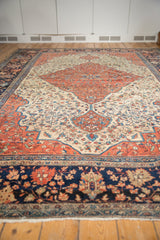 Antique Farahan Sarouk rug's navy floral main border, unique pawn motif, and white fringe.