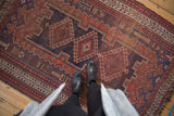 Antique Afshar rug: navy, madder red triple medallion, hook and latch motifs, with pile wear.