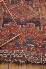 Tattered fringe and visible wear across knot heads on the antique Afshar rug.