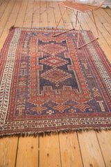 Tattered goat hair fringe and geometric navy blue, madder red border on an antique Afshar rug.