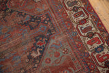 Antique Qashqai rug with visible foundation wear and geometric red and ivory border.