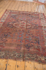 Lower fringed end of the Antique Qashqai rug with geometric border and naturally worn pile.