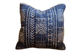 Indigo mudcloth throw pillow with beige geometric patterns and visible jute piping, 16x16.