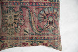 Antique Persian Kerman rug fragment pillow, featuring faded rose and blue curvilinear floral motifs.