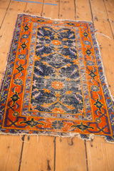 Cobalt blue field with visible wear and Herati-inspired motifs, bordered by tangerine palmettes.