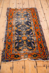 Worn Herati motif on cobalt blue field with tangerine border and tattered end.