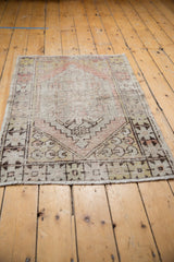 Distressed vintage Oushak rug corner, geometric spandrel, worn pile, terracotta and saffron.