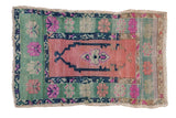 Distressed Oushak rug with faded rose medallion, mint green wide border, and bright pink florals.