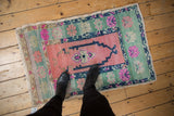 Distressed vintage Oushak rug with dusty rose field, unusually wide mint green border, floral motifs.
