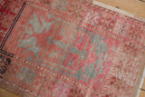 Distressed vintage Oushak rug showing plant motifs in dusty raspberry and oxidized silver tones.
