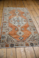 Distressed vintage Oushak runner, terracotta field, diamond medallion, visible pile wear.