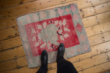 Textured vintage distressed Oushak rug with blush, cherry red, and silver floral patterns.