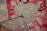 Hand-knotted reverse and distressed pile of vintage Oushak rug with blush and cherry red tones.