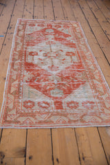 Distressed texture of the vintage Oushak runner, highlighting brick red and ivory tones.