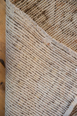 Hand-knotted Oushak rug foundation detail, with visible wear, beige tones, and intact side selvage.