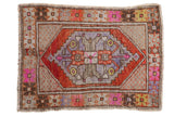 Distressed Oushak rug featuring a faded diamond medallion in rust, fuchsia, grey, 2.5x3.5.