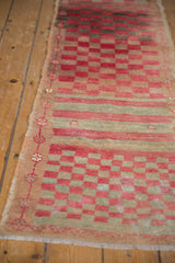 Distressed cherry red and pale seafoam green checkered motif, Oushak runner's meandering floral border.