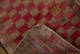 Textured, distressed checkered pile and hand-knotted foundation of a vintage Oushak runner.