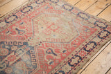 Distressed Oushak rug runner side with brick red and navy patterned border, original selvage.